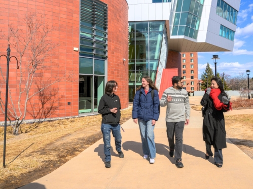 Students walking and talking across campus